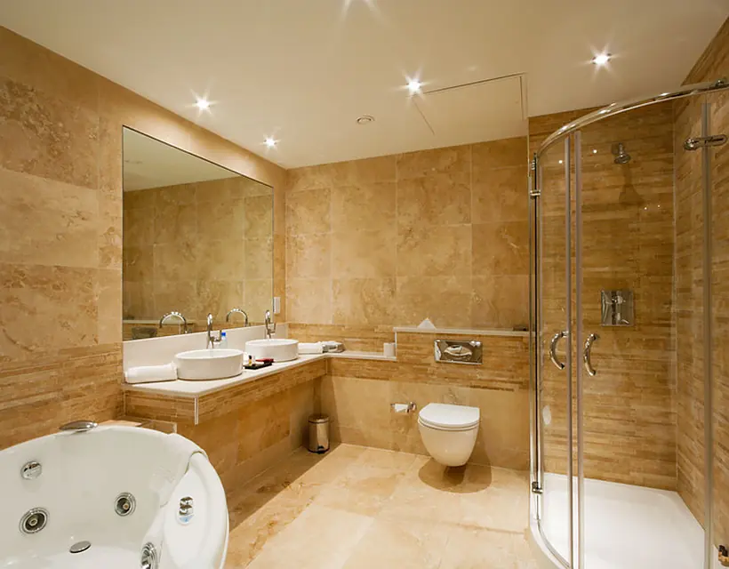 Travertine bathroom with a walk-in glass shower