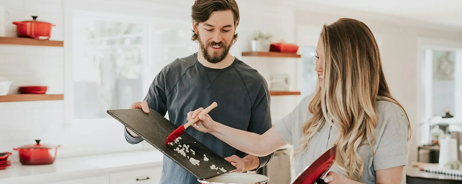 Couple cooking together in a newly remodeled kitchen