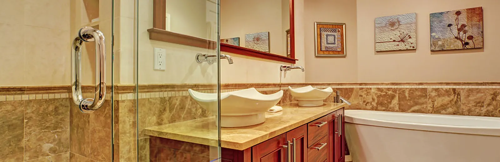 Bathroom remodel with double vessel sinks on a cherry vanity