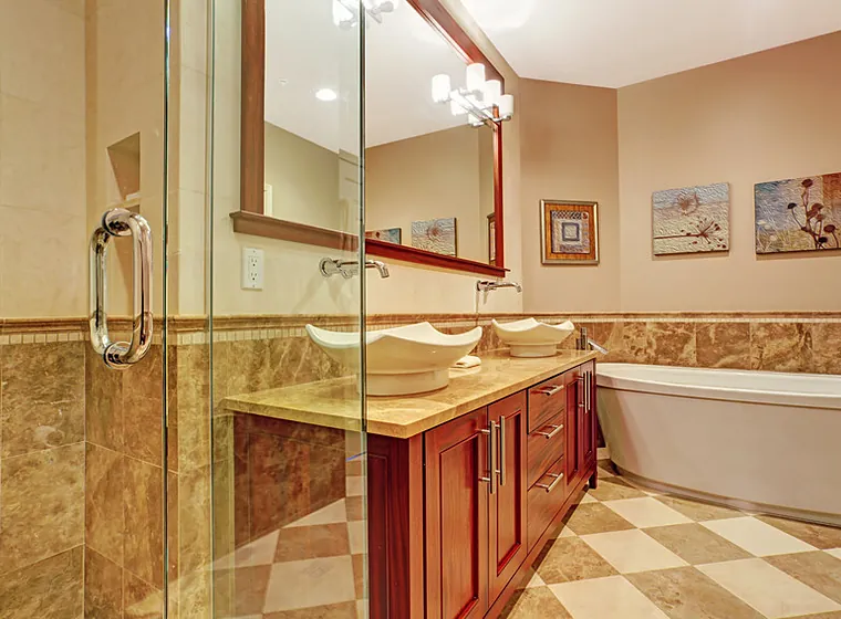 Bathroom remodel with double vessel sinks on a cherry vanity