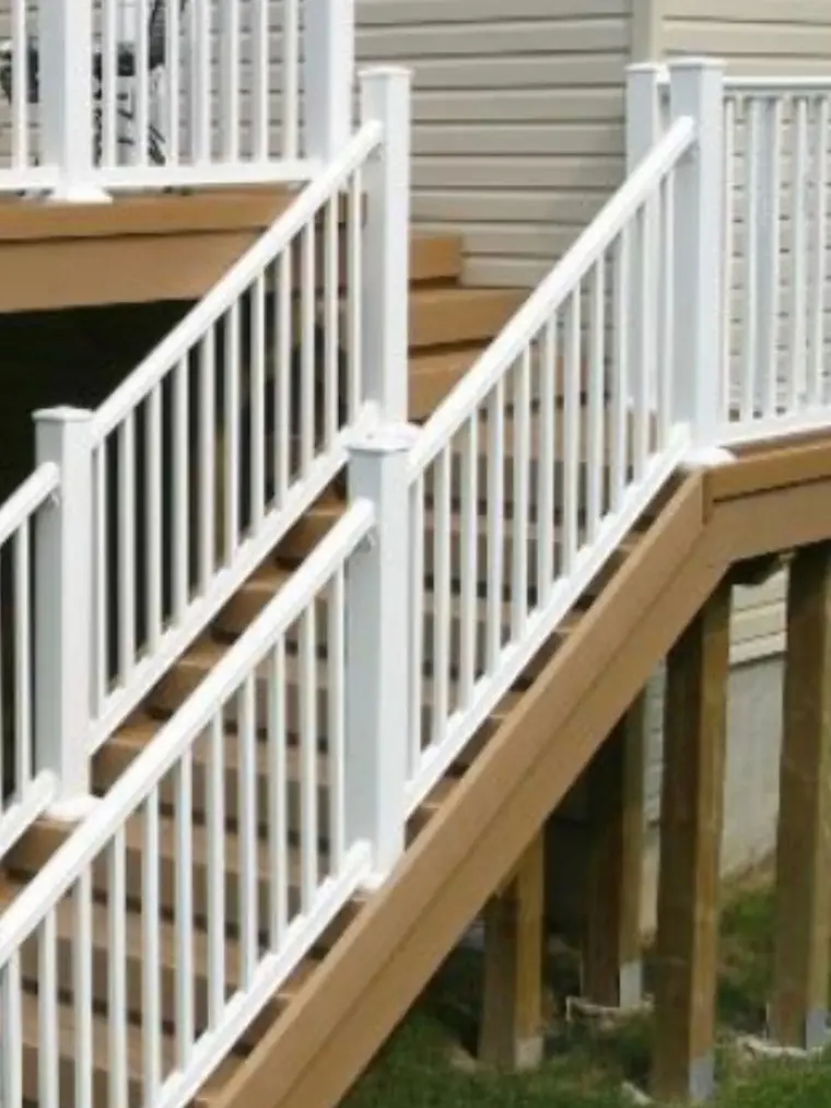 New white deck stairs and railings on a raised deck