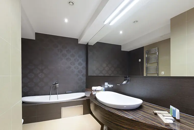 Modern bathroom with a dark feature wall and vessel sink