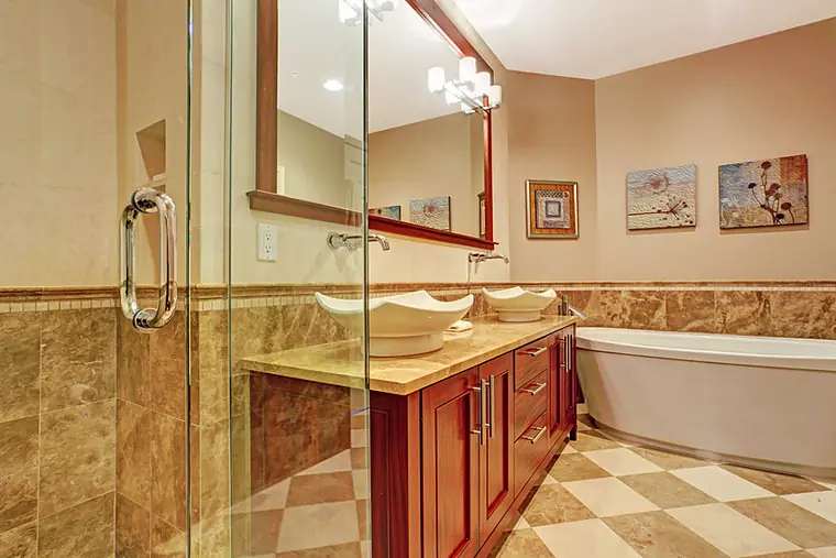 Bathroom remodel with double vessel sinks on a red cherry vanity