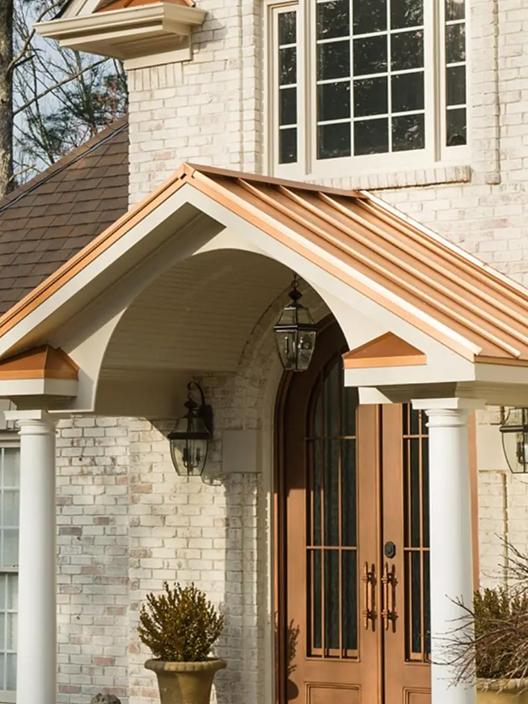 Front entry addition with a copper standing-seam portico roof