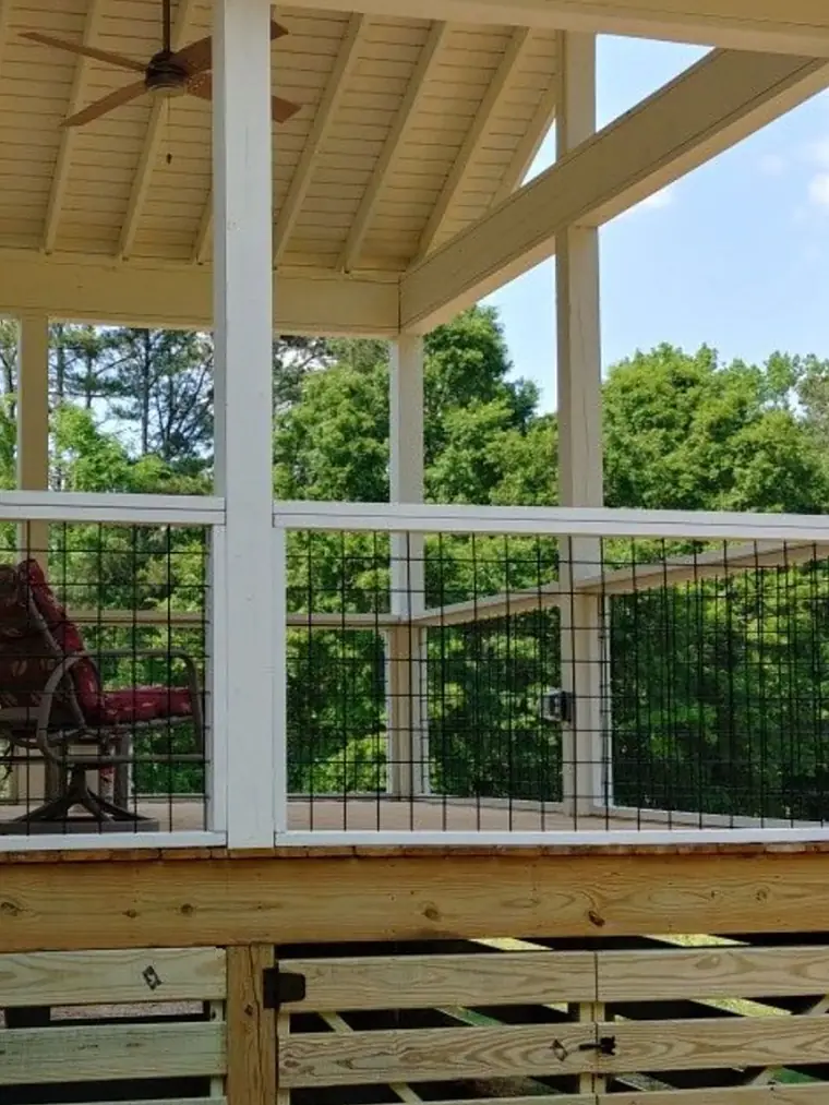 Covered porch with a wood ceiling and white columns