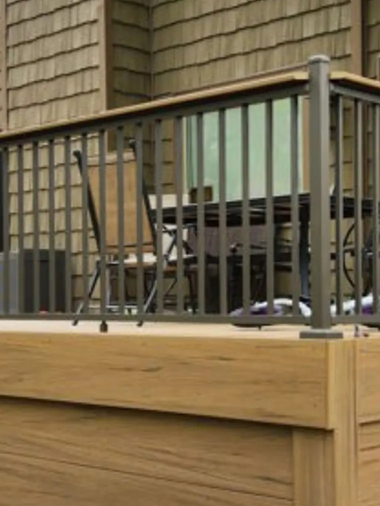 Deck with black metal balusters and a wood top rail
