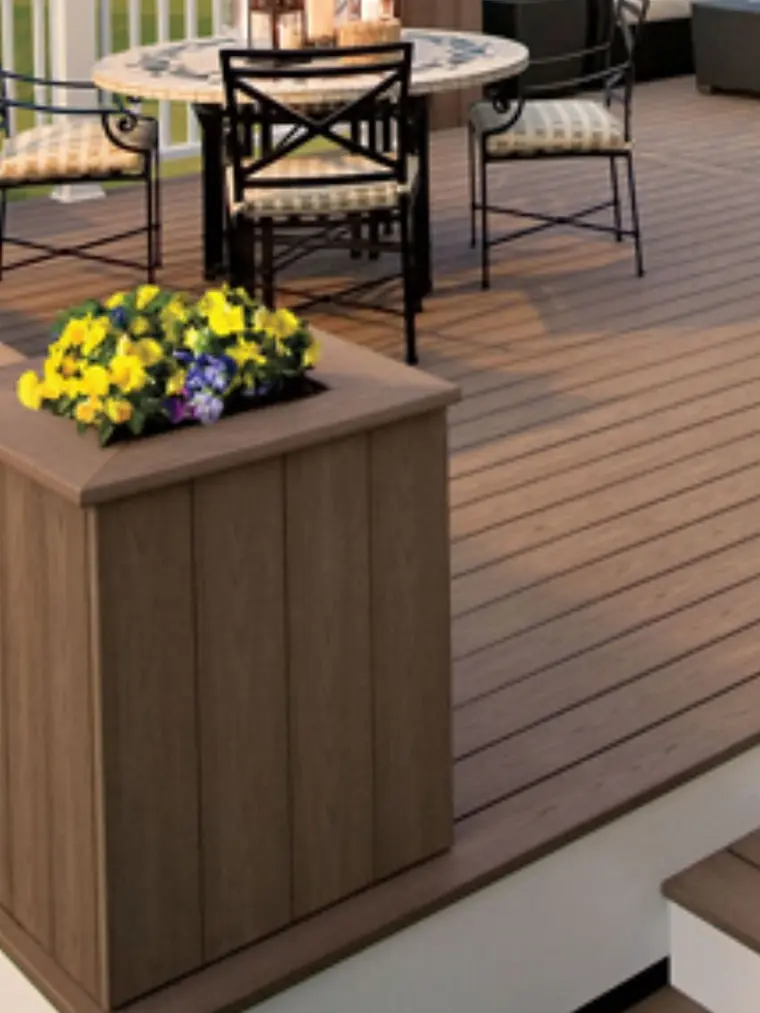 Composite deck with a wood planter box and outdoor seating