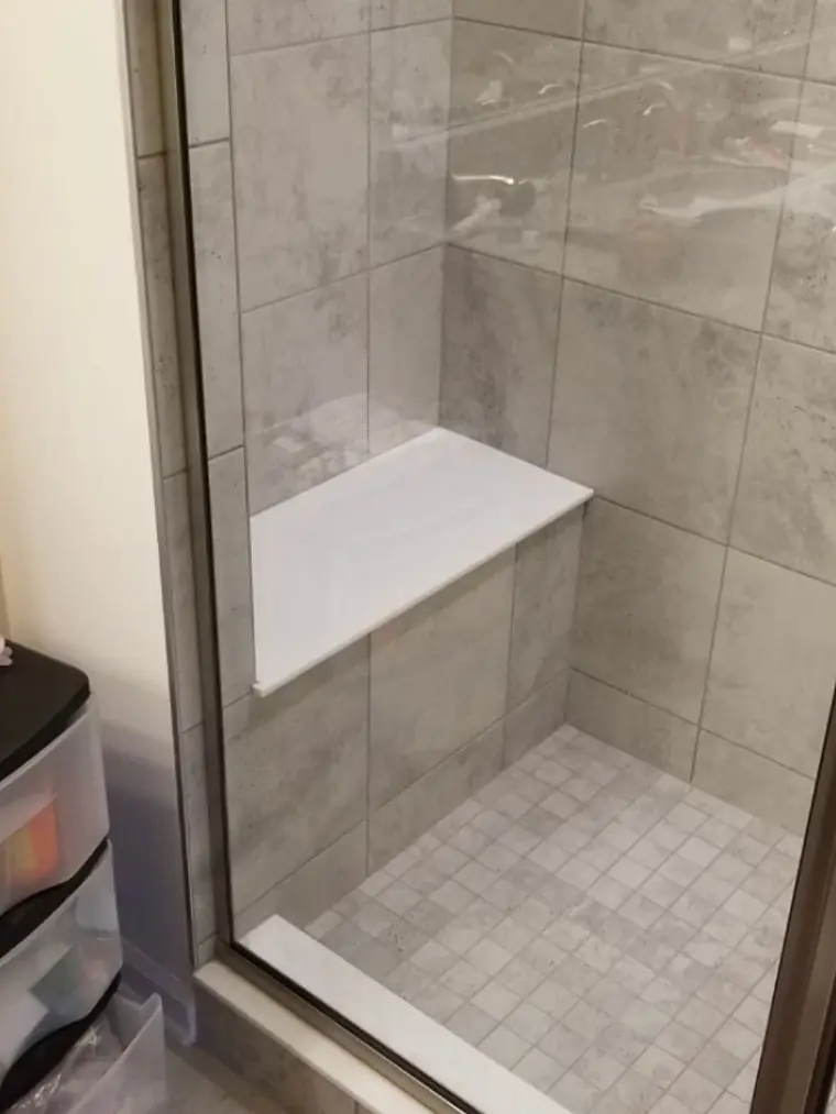 Walk-in shower with a built-in bench and large format tile