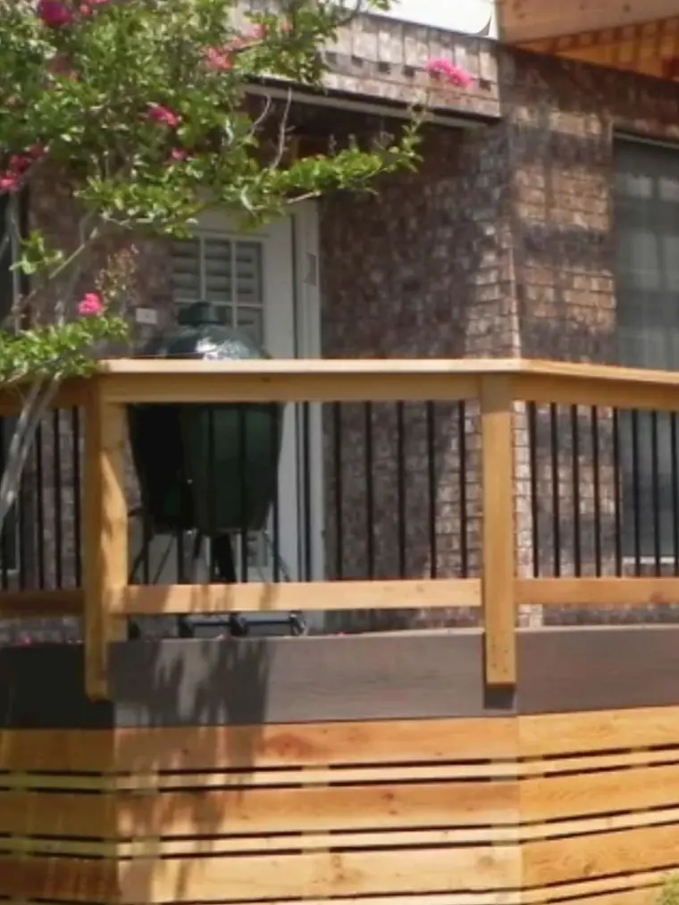 Wood deck railing with a stacked stone pier