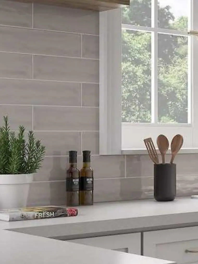Gray plank tile backsplash below a kitchen window
