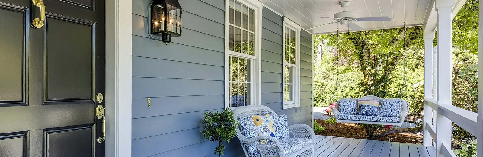 Home addition with a new covered entry and stone porch columns