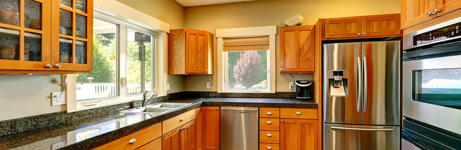 Remodeled kitchen with white shaker cabinets and a quartz island