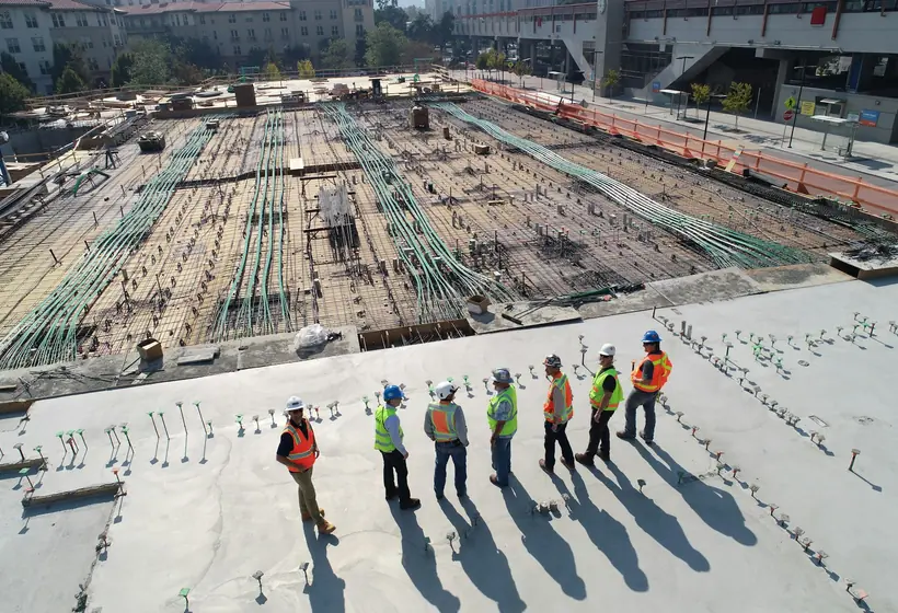 Freshly poured and finished concrete slab beside a home