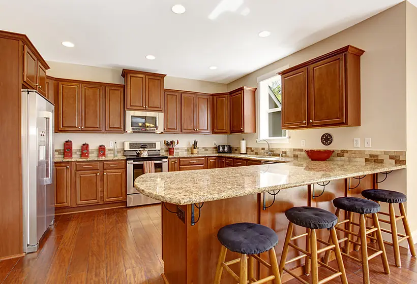Remodeled kitchen with white shaker cabinets and a quartz island